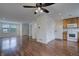 Open concept living room and kitchen featuring modern flooring, fan, and natural light at 19249 E 58Th Ave # D, Denver, CO 80249