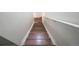 A clear view of hardwood stairs featuring white risers and railing at 19249 E 58Th Ave # D, Denver, CO 80249