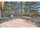Private backyard featuring a stone patio, stainless steel grill, mature trees and a wood fence at 5461 S Youngfield Ct, Littleton, CO 80127