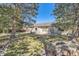 This backyard features a brick patio and mature landscaping that provides privacy at 5461 S Youngfield Ct, Littleton, CO 80127
