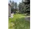 Expansive backyard featuring lush lawn, mature trees, and a serene garden area, perfect for outdoor enjoyment at 5461 S Youngfield Ct, Littleton, CO 80127