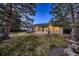 This backyard features mature landscaping, and an outdoor patio at dusk at 5461 S Youngfield Ct, Littleton, CO 80127