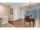 Dining room featuring hardwood floors, glass block feature and adjacent to the kitchen and main entrance at 5461 S Youngfield Ct, Littleton, CO 80127