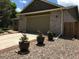 Home exterior featuring a brick facade, a three car garage, and landscaping at 5461 S Youngfield Ct, Littleton, CO 80127