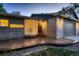 Exterior shot showcasing the unique curved glass-block window and the home's front door at 5461 S Youngfield Ct, Littleton, CO 80127