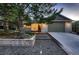 Charming front exterior with brick, modern curb appeal, mature landscaping, and an attached garage at 5461 S Youngfield Ct, Littleton, CO 80127