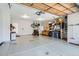 Spacious two-car garage with overhead storage, bicycle lift, and ample space for vehicles and tools at 5461 S Youngfield Ct, Littleton, CO 80127