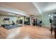 Well-equipped home gym featuring various exercise machines, weights, and ample workout space at 5461 S Youngfield Ct, Littleton, CO 80127
