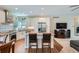 Modern kitchen featuring an island, stainless steel appliances, granite countertops, and hardwood floors at 5461 S Youngfield Ct, Littleton, CO 80127