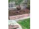 Landscaping featuring a retaining wall, mulch, and a variety of colorful plants at 5461 S Youngfield Ct, Littleton, CO 80127