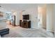 Comfortable open-concept living area with carpet and a view into the modern kitchen and adjacent bathroom at 5461 S Youngfield Ct, Littleton, CO 80127
