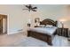 Spacious main bedroom featuring a walk-in closet and comfortable king-size bed with dresser and nightstands at 5461 S Youngfield Ct, Littleton, CO 80127