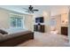 Main bedroom with a large window and TV, adjacent to the ensuite bathroom with a glass block accent at 5461 S Youngfield Ct, Littleton, CO 80127