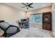 Home office with a large window, modern desk setup, and comfortable massage chair at 5461 S Youngfield Ct, Littleton, CO 80127