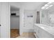 Bathroom with white tiling, a shower-tub combo, and a vanity with a marble countertop at 1716 W Sunset St, Longmont, CO 80501