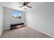 Bright bedroom with a ceiling fan, large window, and a dark-colored media console at 1716 W Sunset St, Longmont, CO 80501