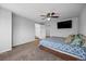 Spacious bedroom featuring a ceiling fan and an attached bathroom with a large mirror at 1716 W Sunset St, Longmont, CO 80501