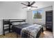 Bedroom with a large window, ceiling fan, and dark-colored shelving unit at 1716 W Sunset St, Longmont, CO 80501