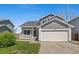 Charming two-story home featuring a well-manicured lawn and an attached two-car garage at 1716 W Sunset St, Longmont, CO 80501