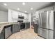 Well-lit kitchen featuring stainless steel appliances and tile flooring at 1716 W Sunset St, Longmont, CO 80501