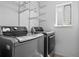 Laundry room with silver washer and dryer units and white wire shelving at 1716 W Sunset St, Longmont, CO 80501
