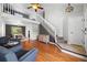 Bright, open-concept living room with hardwood floors, a staircase, and natural light at 1716 W Sunset St, Longmont, CO 80501