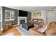 Comfortable living room with a fireplace, mounted television and cozy leather sofas at 1716 W Sunset St, Longmont, CO 80501