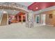 Large basement area with carpet flooring, stone archway, and open space for customization at 670 Independence Dr, Larkspur, CO 80118