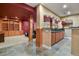 Basement featuring slate floors, bar with wood cabinets, granite countertops, and a cozy atmosphere at 670 Independence Dr, Larkspur, CO 80118