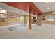 Open basement featuring carpeted floors, stone accent wall, support beams, and neutral color scheme at 670 Independence Dr, Larkspur, CO 80118