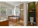 Spacious bathroom features a soaking tub with tiled shower and a separate toilet area for added privacy at 670 Independence Dr, Larkspur, CO 80118