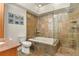 Bathroom with a soaking tub and shower, stone surround, and granite countertop at 670 Independence Dr, Larkspur, CO 80118