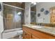 Updated bathroom with a glass-enclosed shower, granite countertop sink, and modern fixtures at 670 Independence Dr, Larkspur, CO 80118
