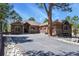 A single Gathering house with stone and stucco accents, long paved driveway, and manicured landscaping at 670 Independence Dr, Larkspur, CO 80118