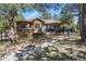 A beautiful two-story house with a backyard and a rock-lined creek at 670 Independence Dr, Larkspur, CO 80118