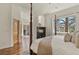 Elegant main bedroom featuring a cozy fireplace and a view to an outside deck through sliding glass doors at 670 Independence Dr, Larkspur, CO 80118