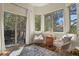 Bright sitting room with multiple windows, an outdoor deck, and two chairs for relaxing and enjoying nature views at 670 Independence Dr, Larkspur, CO 80118