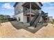 Backyard view with deck, stairs, and sliding glass door. Partially xeriscaped with new growth at 6881 Oak Canyon Cir, Castle Pines, CO 80108