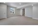 Large basement area with neutral carpet, recessed lighting, and a window view of the outdoors at 6881 Oak Canyon Cir, Castle Pines, CO 80108