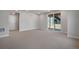 Finished basement with neutral carpet, walkout to the backyard, and ample space for various activities at 6881 Oak Canyon Cir, Castle Pines, CO 80108