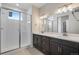 Modern bathroom with double vanity, glass enclosed shower and tile flooring at 6881 Oak Canyon Cir, Castle Pines, CO 80108