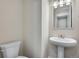 Cozy powder room featuring a pedestal sink and neutral color palette at 6881 Oak Canyon Cir, Castle Pines, CO 80108