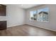 A dining room with wood look flooring, bright walls, and windows with views of the neighborhood at 6881 Oak Canyon Cir, Castle Pines, CO 80108