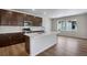 Bright kitchen featuring a large island with seating, stainless steel appliances, and contemporary finishes at 6881 Oak Canyon Cir, Castle Pines, CO 80108
