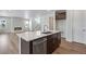 Spacious kitchen with a kitchen island, stainless steel appliances, and open-concept layout with fireplace at 6881 Oak Canyon Cir, Castle Pines, CO 80108