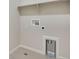 Small laundry room featuring tile floors, laundry hookups, and a functional layout at 6881 Oak Canyon Cir, Castle Pines, CO 80108