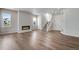 Bright living room with hardwood flooring, modern fireplace, and a staircase at 6881 Oak Canyon Cir, Castle Pines, CO 80108