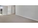 Neutral carpeted loft area with white railing, a view to the exterior and an entry door at 6881 Oak Canyon Cir, Castle Pines, CO 80108