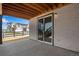Covered patio featuring a sliding glass door entrance and white brick siding at 6881 Oak Canyon Cir, Castle Pines, CO 80108