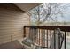 Balcony with outdoor chairs and a view of the parking lot and surrounding trees, creating a cozy outdoor space at 218 Wright St # 303, Lakewood, CO 80228